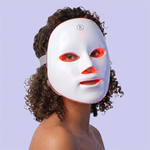 Woman wearing GlowUp LED red light therapy mask, front view